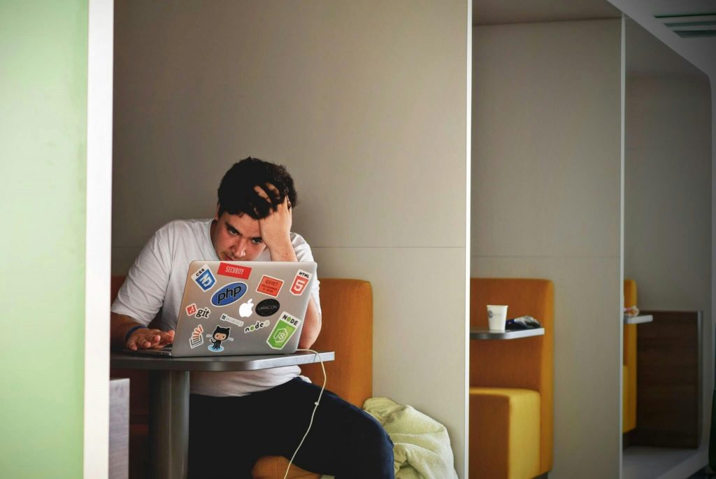man on laptop | neurofeedback for anxiety | neurofeedback therapy in denver, co | neurofeedback therapy for anxiety | neurofeedback therapist | 80126 | 80129 | 80130 Image of an anxious man running his hand through his hair while working on a laptop. If you are stressed and anxious due to work or school, learn how neurofeedback therapy for anxiety in Denver, CO can help you.