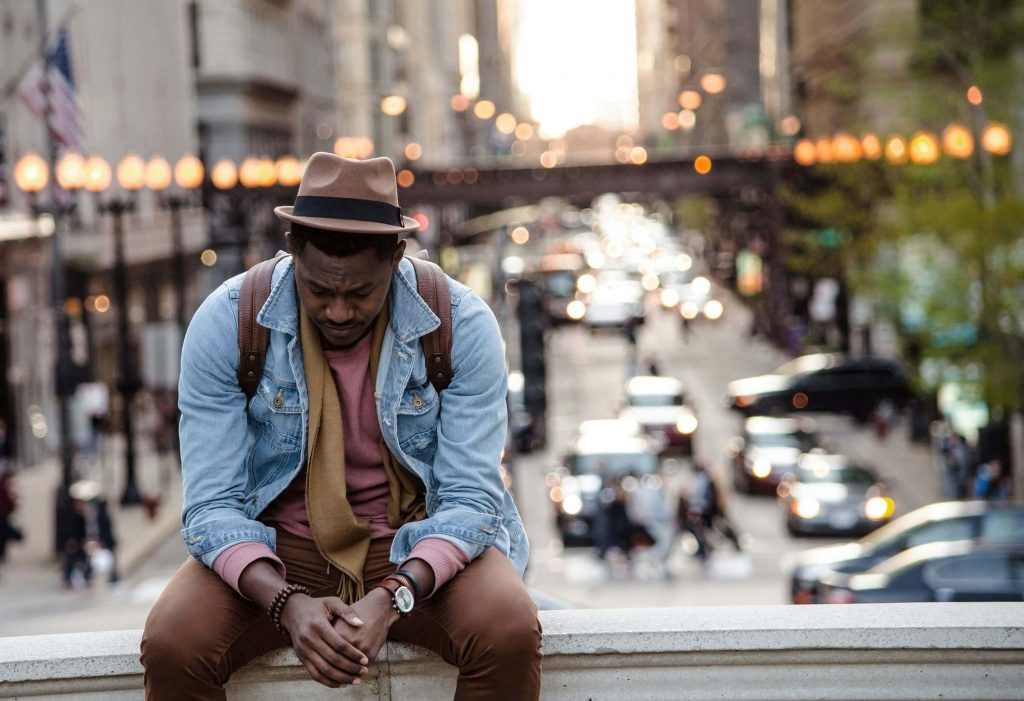 upset man on bridge | emdr therapy in denver, co | emdr therapist in denver, co | emdr trauma therapy | emdr for ptsd | online therapy in colorado | 80126 | 80129 | 80130 Image of an upset man sitting on a concrete bridge above a busy city street. If you struggle to overcome trauma, learn how EMDR therapy in Denver, CO can help you reclaim peace.