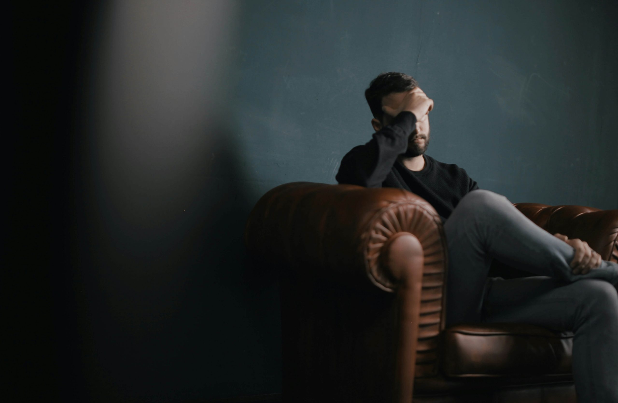 stressed man | anxiety therapy in englewood, co | anxiety therapist in englewood, co | neurofeedback therapy for anxiety | social anxiety treatment | ocd therapy | panic attack treatment | 80126 | 80129 | 80130 Image of a stressed man with his hand on his forehead sitting on a leather couch. Discover how you can effectively manage your stress and anxiety with the help of an anxiety therapist. Find support with anxiety therapy in Littleton, CO.