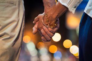 hands close up | couples therapy in greenwood village, co | couples therapy in littleton, co | couples therapy in englewood, co | 80127 | 80128 | 80124 A close up of a couple holding hands against blurry city lights at night. This could represent how couples therapy in Greenwood Village, CO can offer support with cultivating bonds. Learn more about relationship counseling in Englewood, CO and how couples therapy in Englewood, CO can help today.