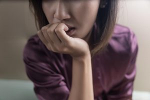 anxious woman | trauma therapist in englewood, co | neurofeedback therapy in littleton, co | child therapy in englewood, co | 80126 | 80129 | 80130 A woman in a deep state of worry, biting her nails and looking distressed. Learn more about how neurofeedback therapy in Littleton, CO can offer support by contacting a trauma therapist in Englewood, CO. They can offer child therapy, anxiety therapy in Englewood, CO and other services.