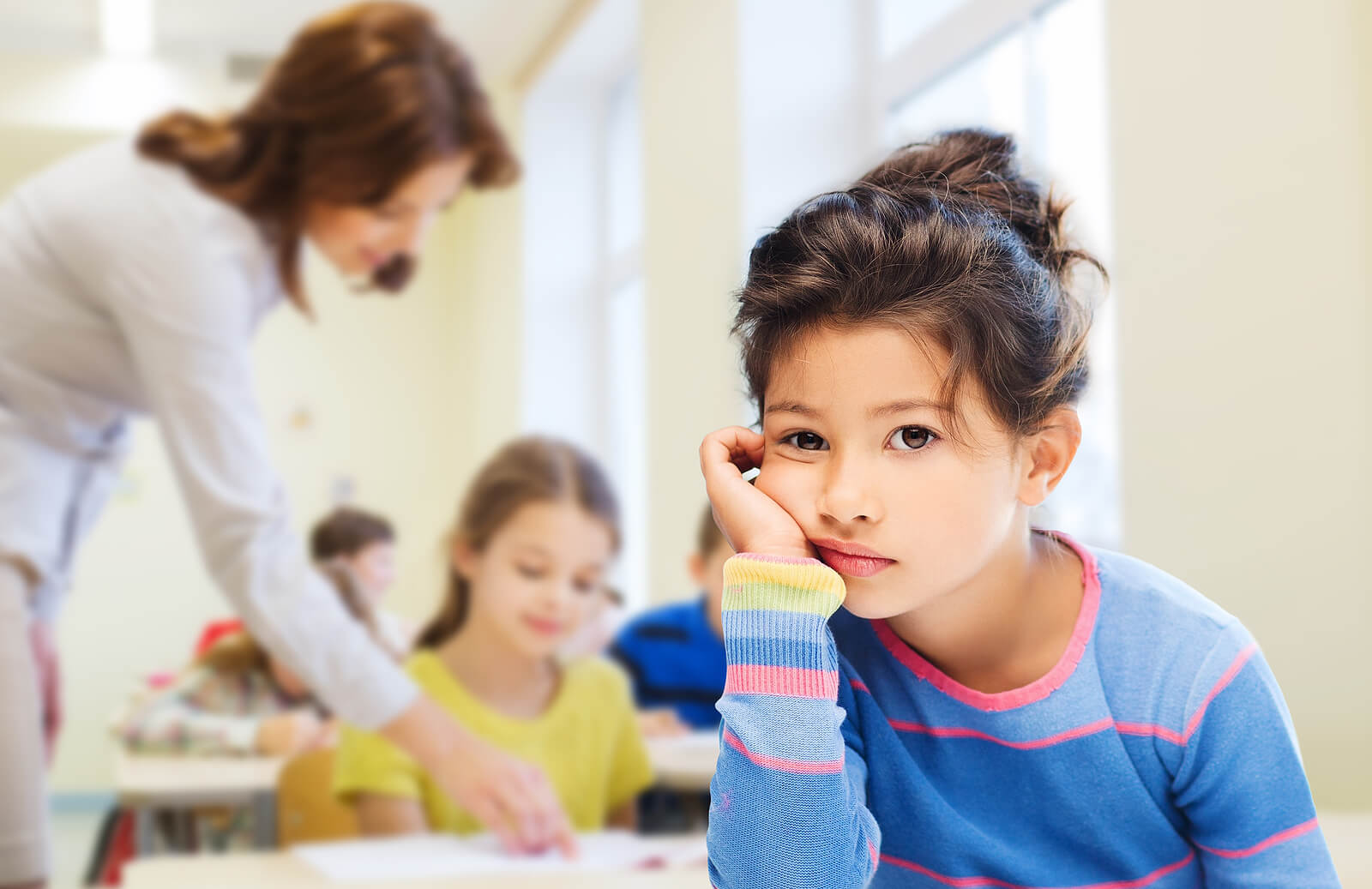 bored child | adhd testing in denver | adhd testing in denver | child therapist in englewood, co | denver, co | littleton, co | englewood, co Child looking distracted in a classroom, illustrating when parents might seek adhd testing in Greenwood Village, CO, adhd testing in Denver, adhd testing in Littleton, CO, or support from a child therapist in Englewood, CO.