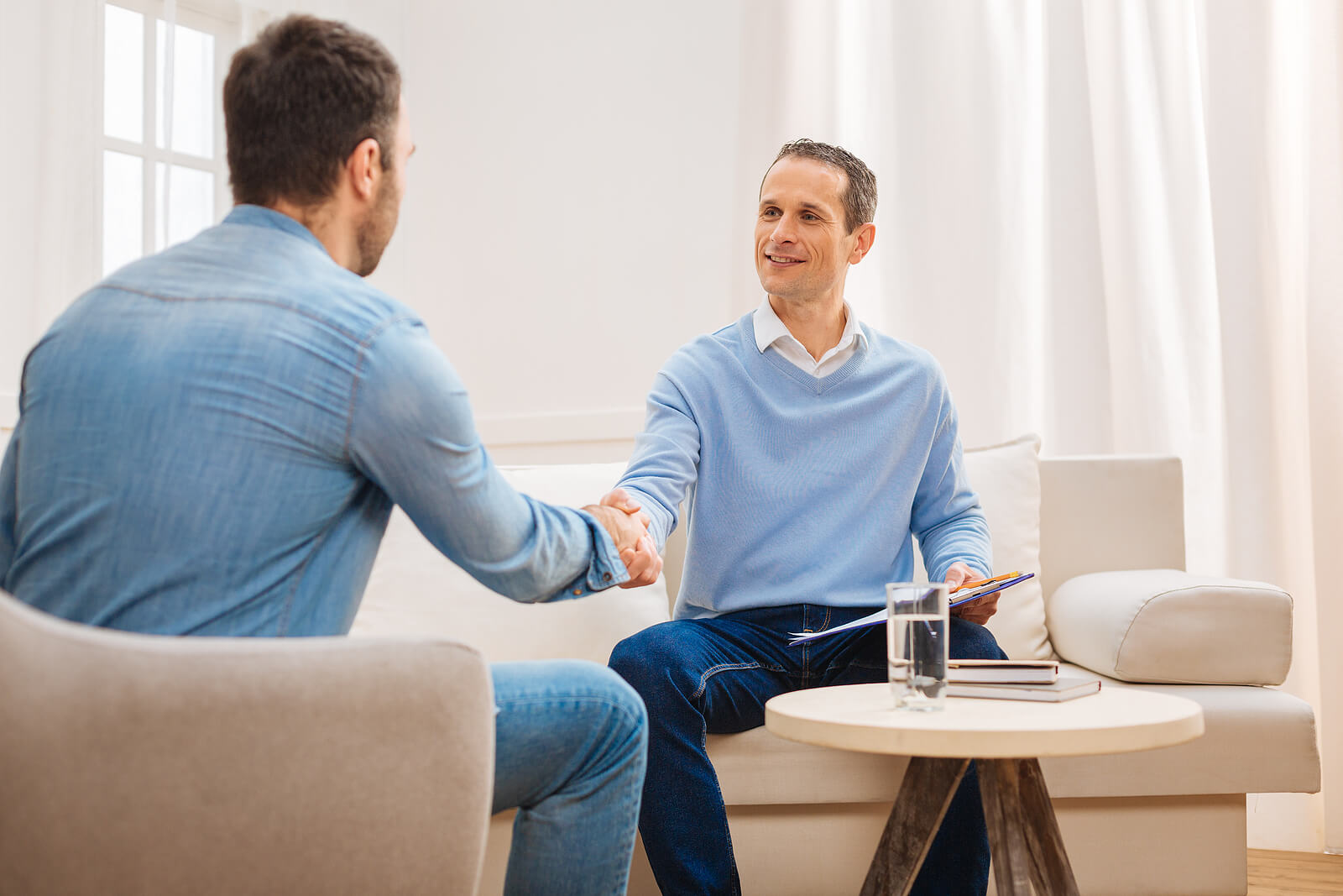 helpful specialist | autism testing for adults colorado | autism testing in littleton, co | adult autism diagnosis denver | greenwood village, co | littleton, co | englewood, co Provider and client shake hands during an intake session, reflecting the start of an autism evaluation denver, planning autism testing for adults colorado, and guidance after an adult autism diagnosis denver.